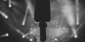 black and white image of microphone in the spotlight